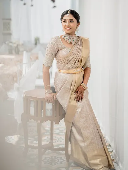 A full-length portrait of Monisha, showcasing her graceful posture and the beautiful drape of her saree. Her entire look is a testament to timeless style and sophisticated taste.