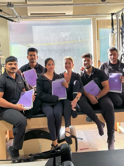Our team proudly displaying their training manuals. We are committed to continuous education to provide the highest quality instruction.