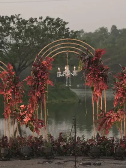 The full set of three arches by the lake, creating an impressive and cohesive backdrop for the welcome dinner.