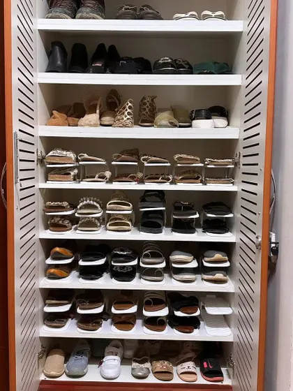 A shoe collection deserves a great setup. Using shoe slots, we were able to fit this client's entire collection neatly into one shoe rack, with every pair visible.
