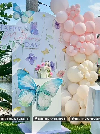 A beautiful setup for Mother's Day, featuring a butterfly and floral-themed backdrop. This shows how I can create decor for any special occasion.