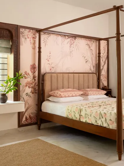 A wide shot of the 'Varnika' master bedroom, showing the four-poster bed and the bay window seat, which was fashioned from leftover marble.