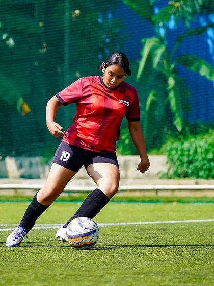 A Vidyashilp School player shows composure on the ball, looking for a pass during the competitive U-15 girls' final.