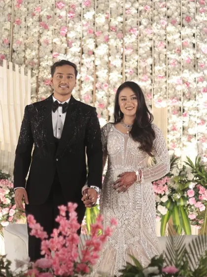 The couple making their grand entrance. The bride's makeup is flawless and photo-ready, ensuring she looks stunning in every picture.