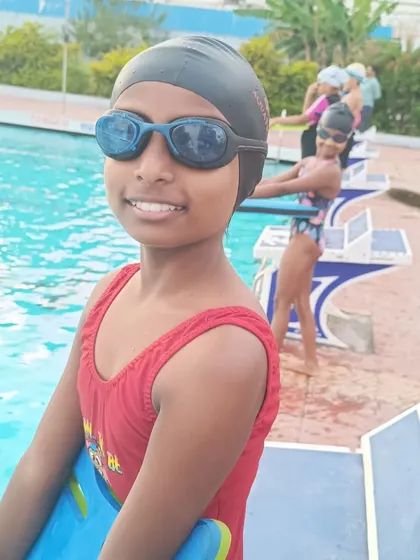 A competitive swimmer with her kickboard, ready for her next set of drills.