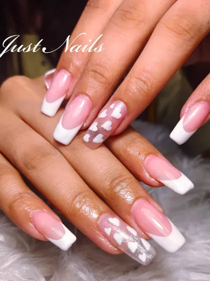 A playful take on the French manicure. This set combines classic white tips with accent nails that have a clear base and delicate white heart patterns, adding a touch of modern romance.