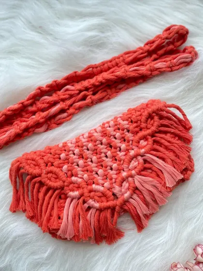 Bright and cheerful, this orange sling bag is like a little burst of sunshine. The design features a mix of orange tones and a fun, fringed flap.
