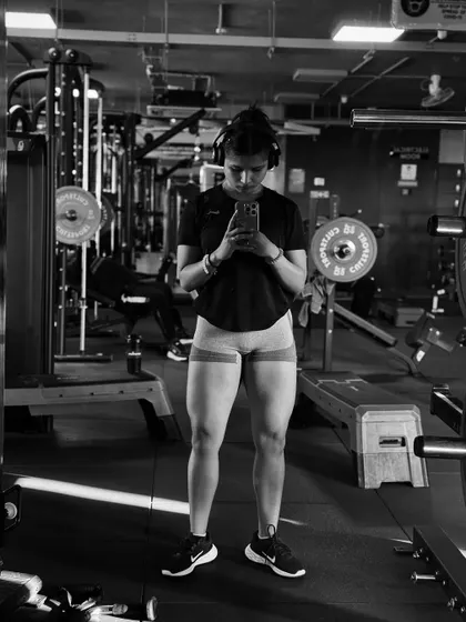 A black and white shot focusing on leg development. Using resistance bands is a great way to activate the glutes and leg muscles before a heavy lifting session.