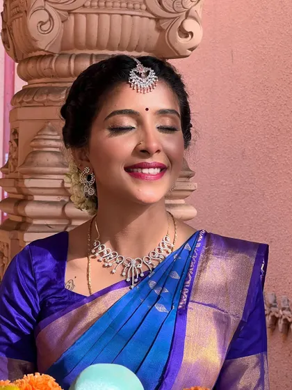 A close-up showing the soft eye makeup and bold red lip, a classic combination for a South Indian bride that exudes confidence and grace.