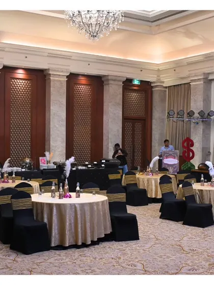The ballroom setup before the party began. The black and gold table settings perfectly matched the Gatsby theme, creating a sophisticated and elegant dining environment.