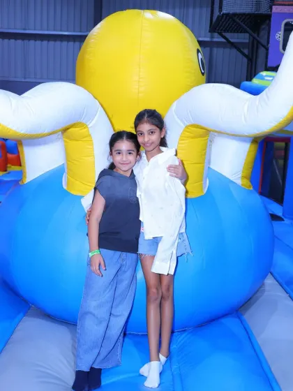 Best friends posing in front of the giant inflatable octopus.