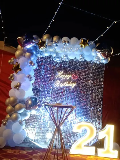 This view shows the full impact of the shimmer wall and fairy lights for a memorable 21st birthday celebration.