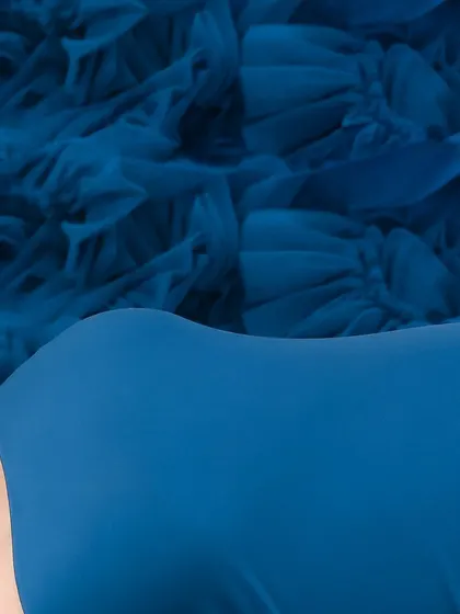 A collection of artistic shots featuring a gorgeous royal blue gown, from full-length portraits to creative close-ups on the fabric and bump.