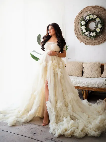 A full-length shot showcasing the incredible texture and flow of this boho-chic ruffled gown. It's a true statement piece.