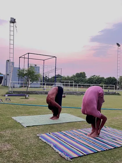 A deep forward fold (Uttanasana) helps to release the spine and hamstrings. We incorporate these essential stretches to improve flexibility and aid in recovery.