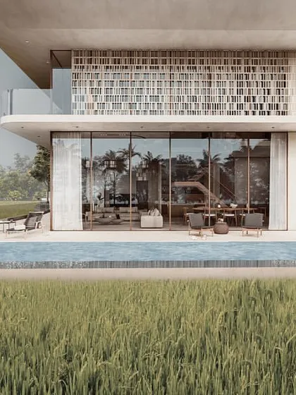 The Pavilion homes are designed with pools that act as water edges between the structure and the surrounding paddy fields. The facade merges perforated screens, double-height glass volumes, and large overhangs softened by cascading plants.