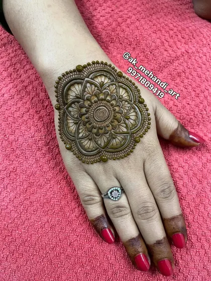 A bold and beautiful floral mandala on the back of the hand, great for making a statement during festive gatherings.