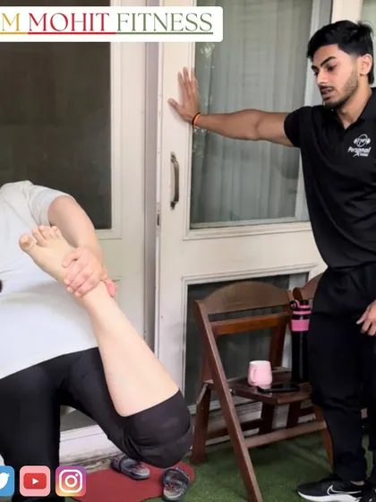 Assisting a client with a quadriceps stretch at home. Flexibility and recovery are just as important as the workout itself.
