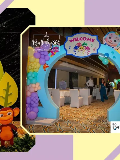 The grand entrance to the Cocomelon party, featuring a large circular arch with a "Welcome" sign and character details.
