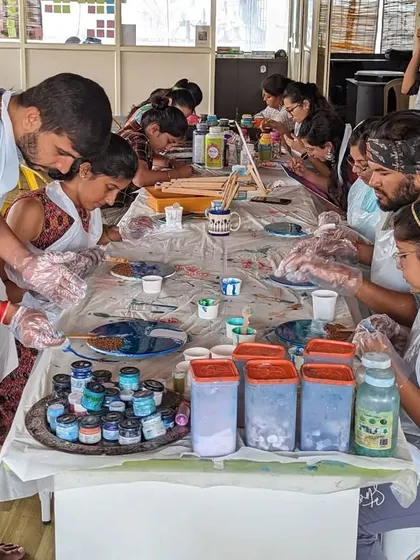 A bustling resin art workshop in session. Our long tables provide plenty of space for everyone to get creative, mix their colors, and bring their resin beach clocks to life.