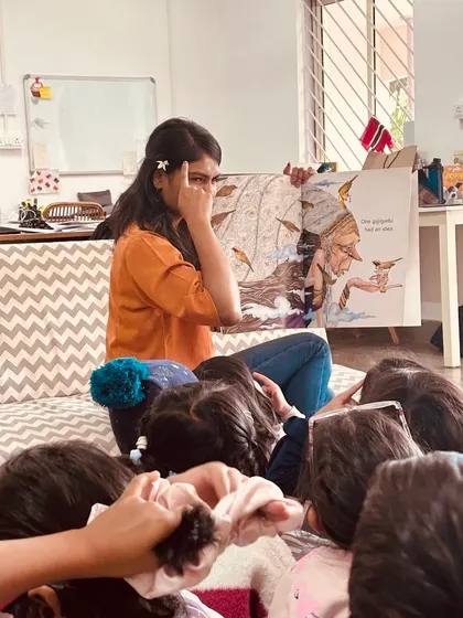 A Playmaker uses facial expressions to bring a character to life during story time. Our Playmakers are master storytellers, creating an immersive and engaging experience for the children.