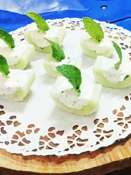 A refreshing and light starter: cucumber cups filled with a creamy herbed cheese. This is a great choice for a summer event or a health-conscious menu.