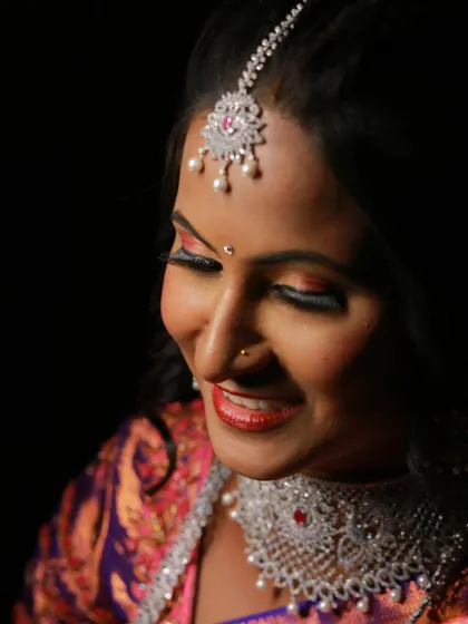 A close-up portrait capturing the serene expression of a bride, with a focus on her intricate diamond jewelry.