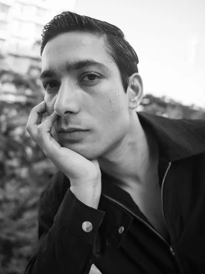A classic, thoughtful black and white headshot for a male actor. The natural light and contemplative expression suggest depth and character.