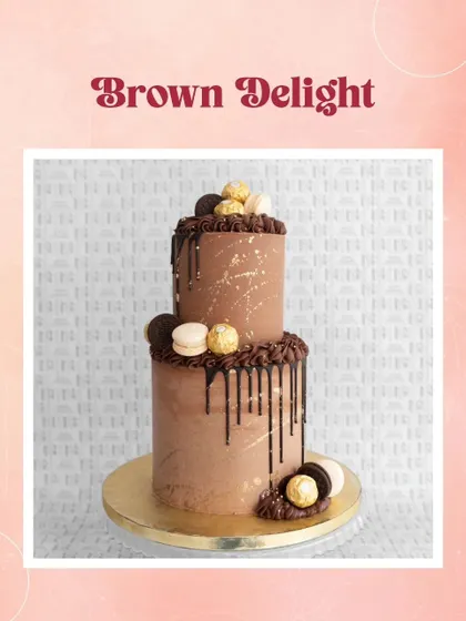 A brown delight! This two-tiered chocolate drip cake is splattered with gold and topped with macarons and Ferrero Rocher.