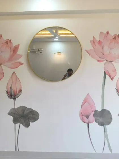 A simple yet elegant lotus mural. The design is placed to work with the round mirror, creating a balanced and serene composition.