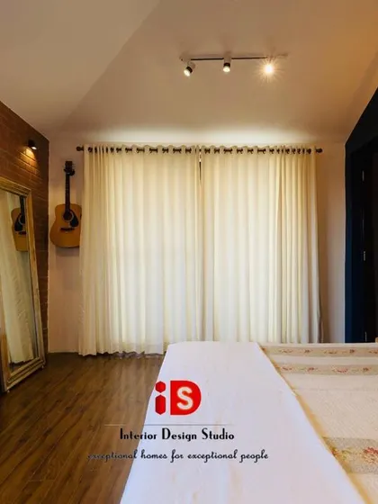 Another view of the brick-walled bedroom, showing the contrast between the rustic wall and the soft, elegant curtains, creating a balanced and inviting space.