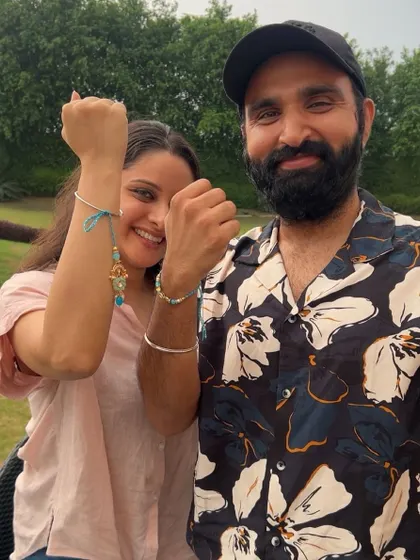 A happy brother and sister duo showing off their matching evil-eye rakhis from my collection.