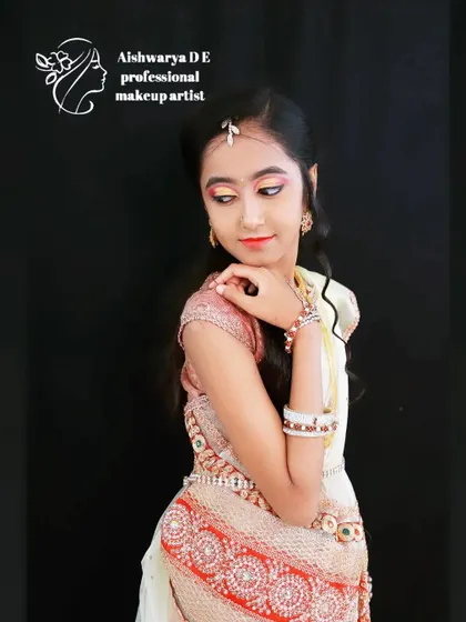 Another angle of this youthful festive look. The focus is on the bright, colorful eye makeup and neatly styled hair, perfect for a young adult attending a family wedding or function.