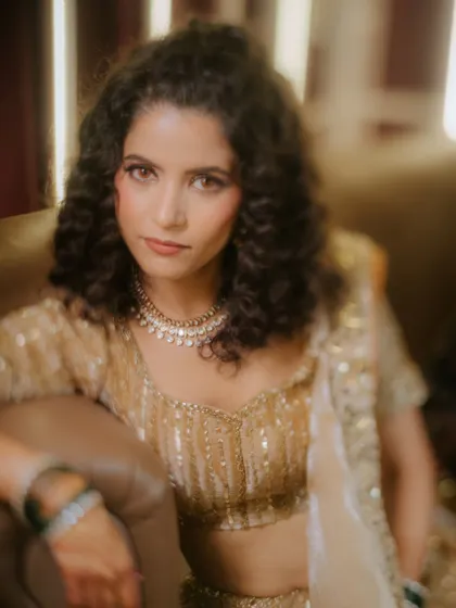 A beautiful, soft-focus portrait of the bride, Shivani, looking poised and elegant during her Sangeet celebration.