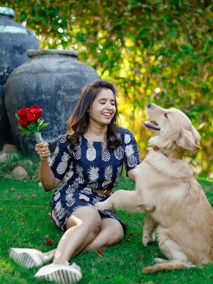 A candid moment from a Pawlentine's Day shoot, where a Golden Retriever offers a paw to his owner. It’s these sweet interactions that make for the most memorable photographs.