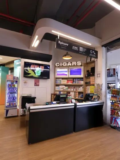 Another view of the checkout area, highlighting the custom lighting fixture and organized shelving. The design ensures that even functional areas of the store are cohesive with the overall premium brand experience.