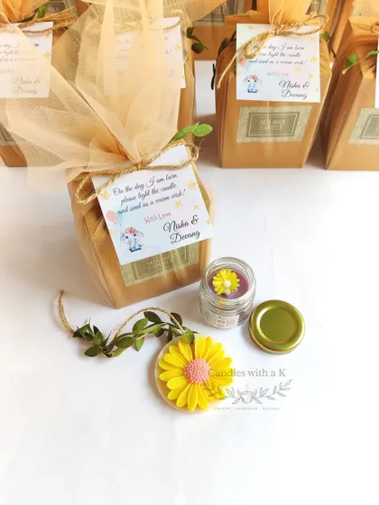 The final packaged gift box for the baby shower, showing the mini candle and wax sachet with a personalized thank you card.