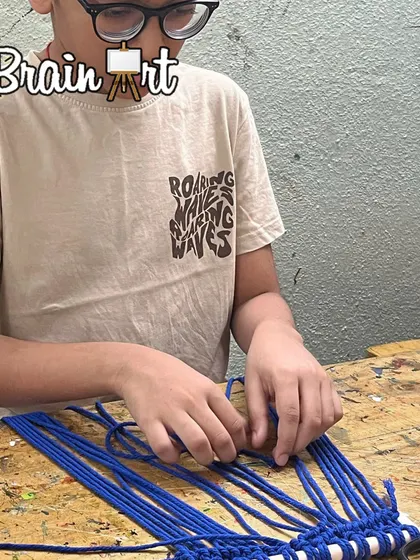 This student is learning the basics of macrame, starting with a simple series of knots. Every artist starts with the fundamentals, and we make sure that process is fun and encouraging.