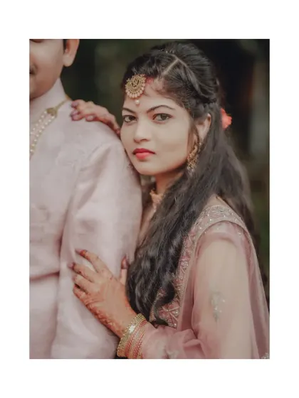 A classic engagement portrait with the bride looking confidently at the camera while resting on her partner's shoulder.