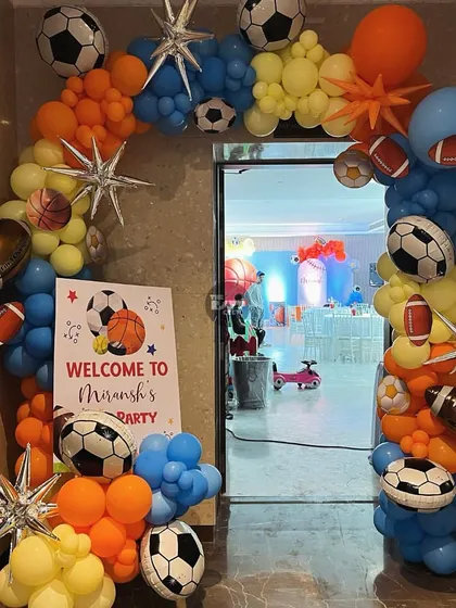 A grand entrance for the little athletes. This balloon arch is packed with soccer balls, footballs, and basketballs, welcoming guests to Miransh's sports party.