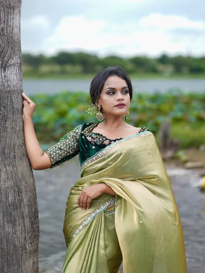 A portrait of elegance in our olive green saree and embroidered velvet blouse.