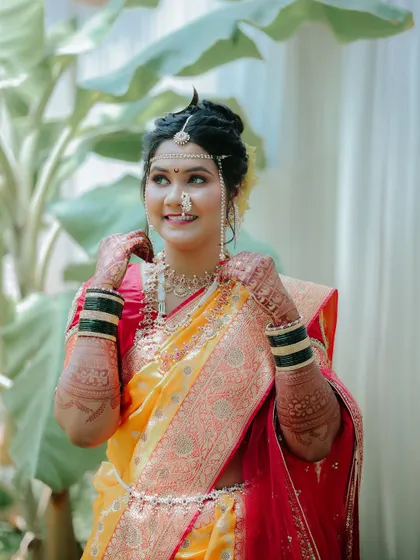 A candid close-up of the bride, capturing her happy expression and the intricate details of her mehndi and jewelry.