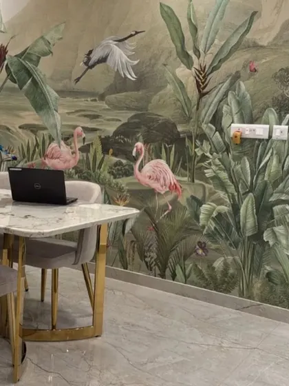 A beautiful dining or work-from-home space is enhanced by a serene mural of flamingos in a lush jungle setting.