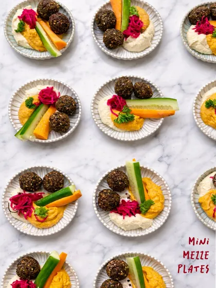 For a taste of the Mediterranean, I create these beautiful mini mezze plates. Each one is a personal platter with two types of house-made hummus, crispy falafel, crunchy veggie sticks, and tangy pickled vegetables.
