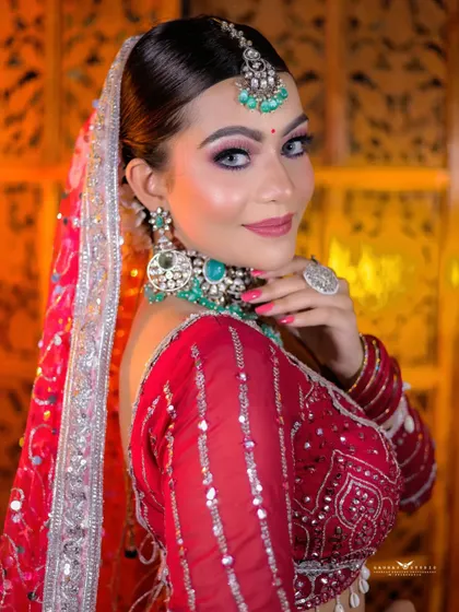 A classic beauty shot, with the bride looking over her shoulder with a confident smile. The lighting perfectly captures her features and the sparkle of her jewellery.