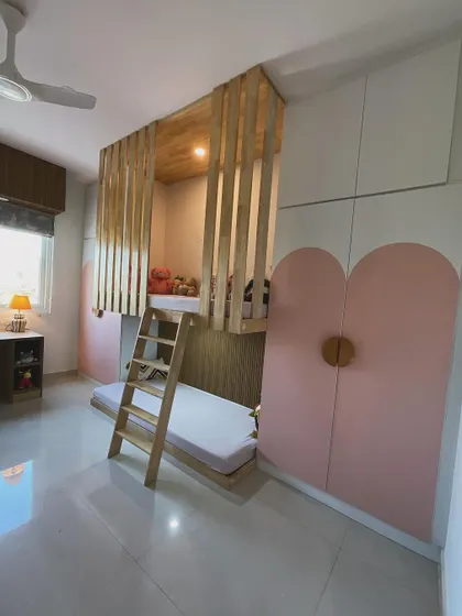 Another angle of the bunk bed and the heart-shaped wardrobe doors, showing the playful and practical design elements we incorporated.