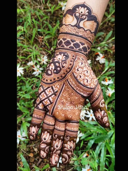 A single hand showing a detailed design with swans on the wrist, perfect for a sangeet or engagement.