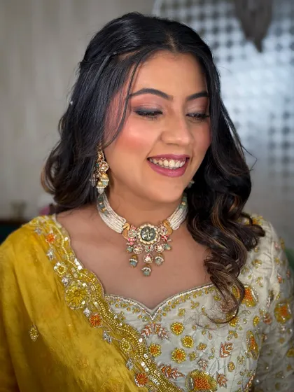 A smiling close-up, showing the soft pink eyeshadow and natural-looking base.