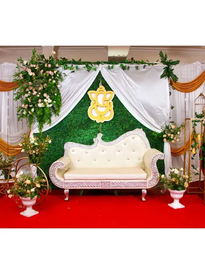 A duplicate image of the elegant baby shower setup with a lush green grass wall.
