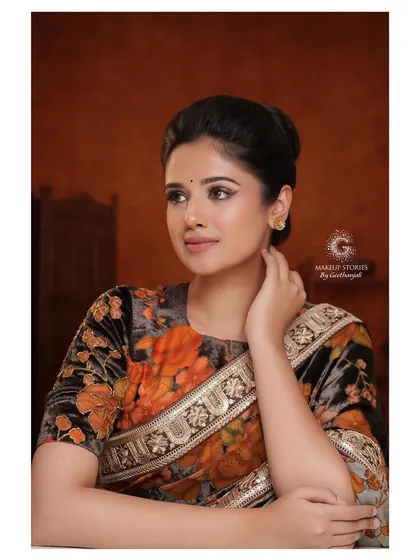 Another elegant pose from the floral saree series. The clean bun and simple jewelry keep the focus on the makeup and the expressive quality of the model.